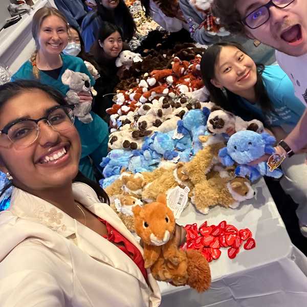 A group of nine CWRU students posing and smiling with stuffed animals.