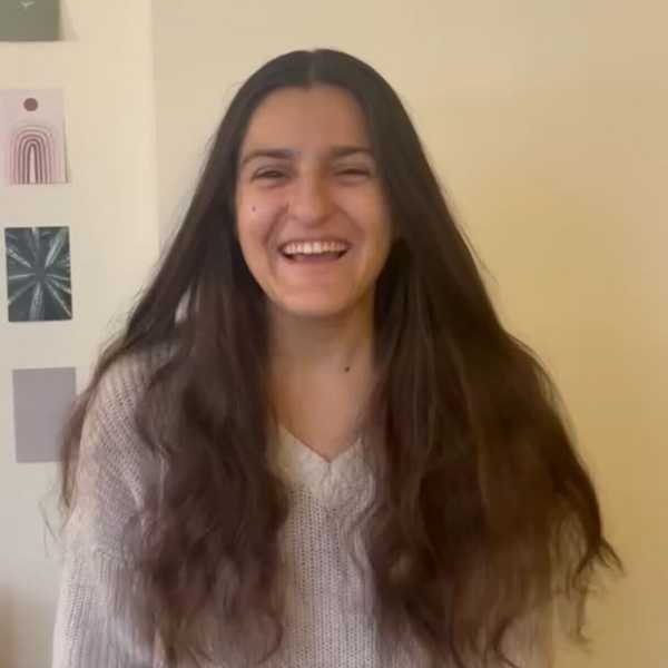 One smiling student with long, wavy hair.