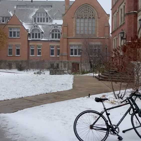 A snowy Mather Quad in the background with a bicycle in the foreground.